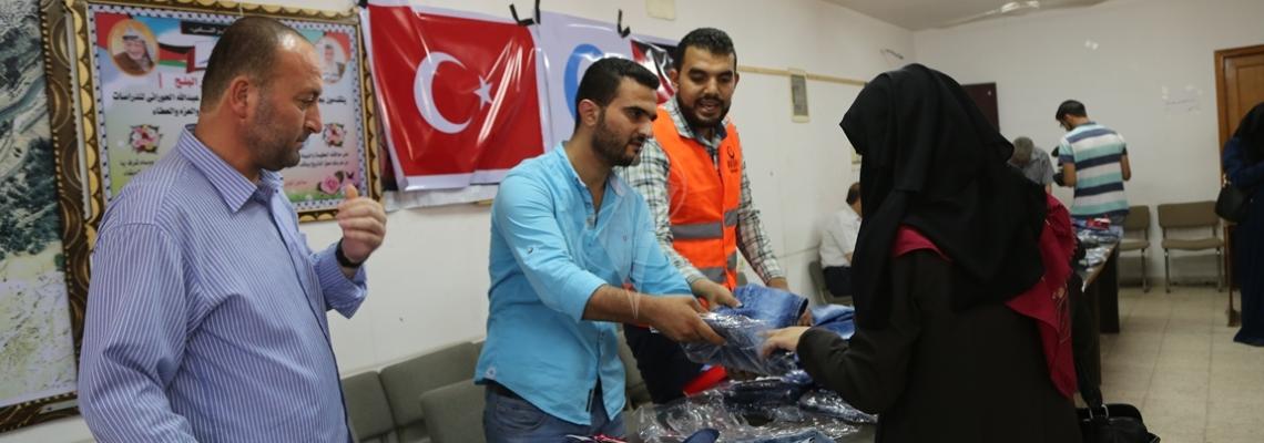 بالصور:العمل النسائي بالتعاون مع جمعية أرض السلام توزع كسوة العيد لمئات الأطفال بغزة
