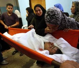 بالصور : مسيرة تشييع الشهيدين في مخيم البريج والقصف الإسرائيلي 