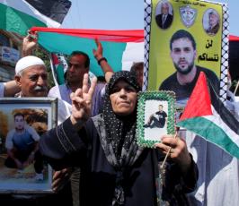 بالصور: سلسلة بشرية ينظمها الصليب الأحمر توصل رسائل الأسرى بالسجون الى ذويهم