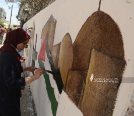 رسم جداريات  امام برج الجوهرة  الذي قصفه الاحتلال بغزة (6)