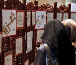 عدسة "فلسطين اليوم" في معرض الصور والكاريكاتور في الجامعة الإسلامية بغزة