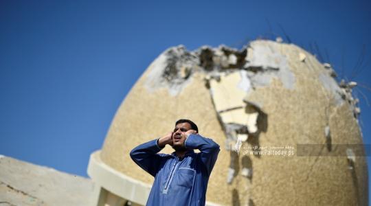 مؤذن يقيم الصلاة من فوق ركام مسجد دمره الاحتلال خلال العدوان على غزة