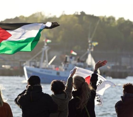 فلسطينيون يلوحون لسفينة تركية