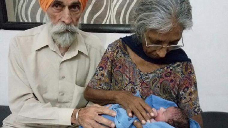 المراة السبعينية تحمل مولودها بجانب زوجها